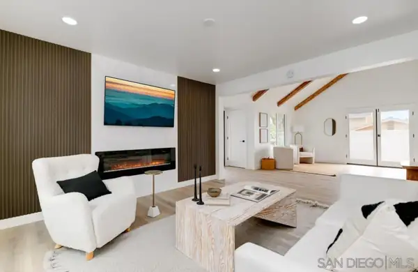 Cardiff: Living room with slatted wood fireplace wall and beamed ceiling beyond
