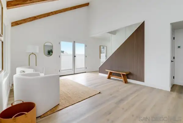 Entry room with slatted wood stair wall