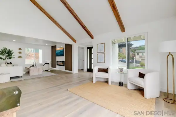 Open living area with exposed wood beams