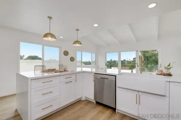 Kitchen peninsula with brass pendants