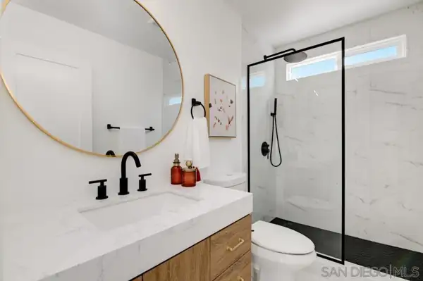 Bathroom with black-framed glass shower