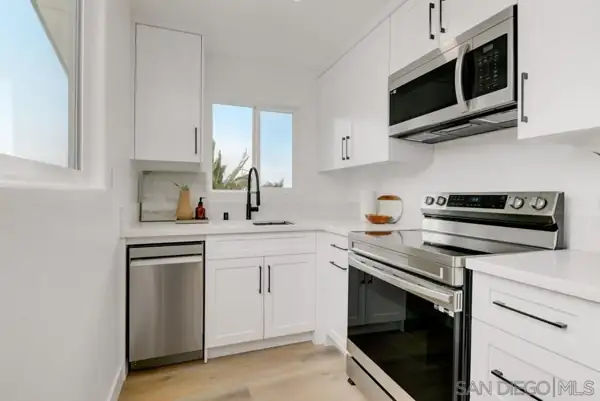 ADU kitchen with white cabinets