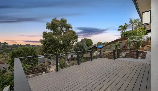Rear deck with cable railing at sunset