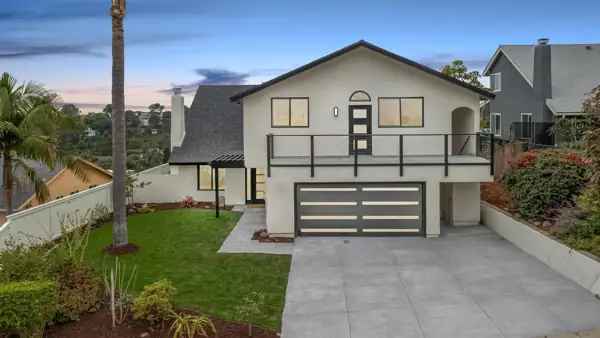 Front exterior with new garage door and balcony