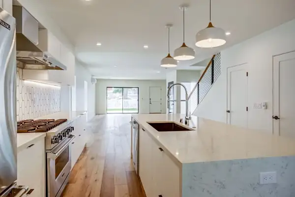 White kitchen looking toward the living area and stairs