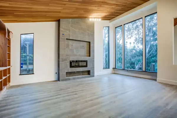 Living room with tiled fireplace wall and wood ceiling