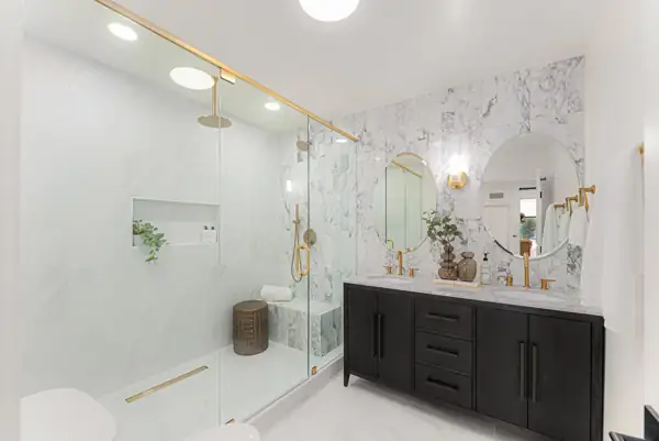 Bathroom with glass walk-in shower and black double vanity