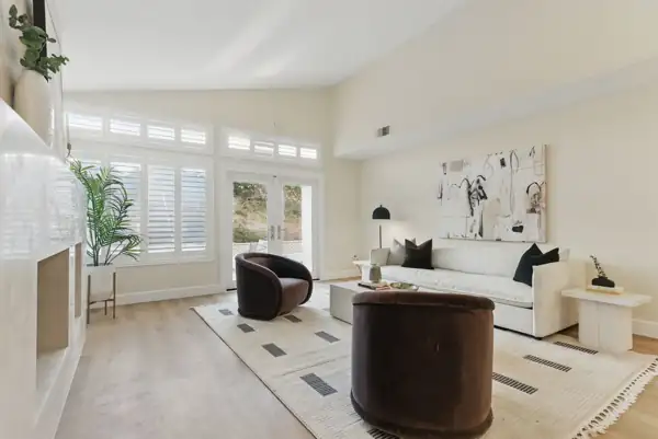 Ocean Hills: Living room with vaulted ceiling, shutters and French doors