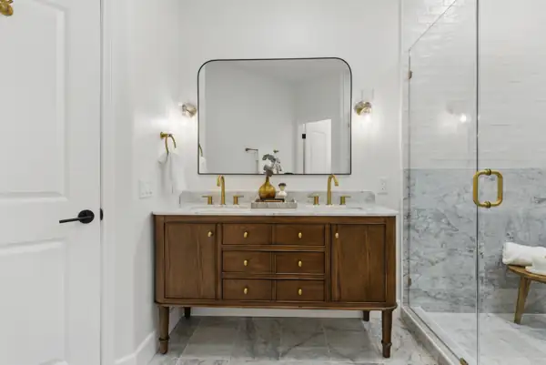 Walnut double vanity with brass fixtures