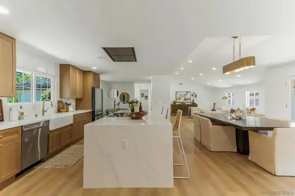 Kitchen island with farmhouse sink wall and dining area