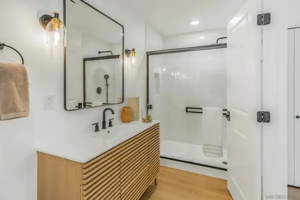 Bathroom with slatted oak vanity and glass shower