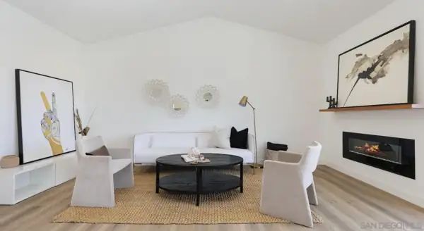 Living room seating with fireplace and wood mantel shelf
