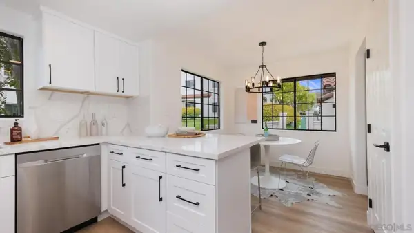 Kitchen peninsula with black hardware and breakfast nook