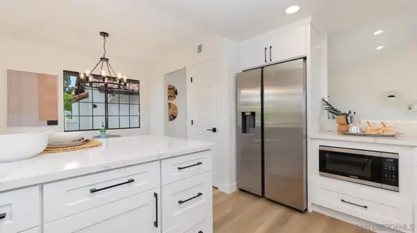Kitchen with built-in refrigerator and microwave