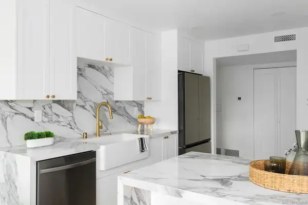 Kitchen sink wall with farmhouse sink and brass faucet