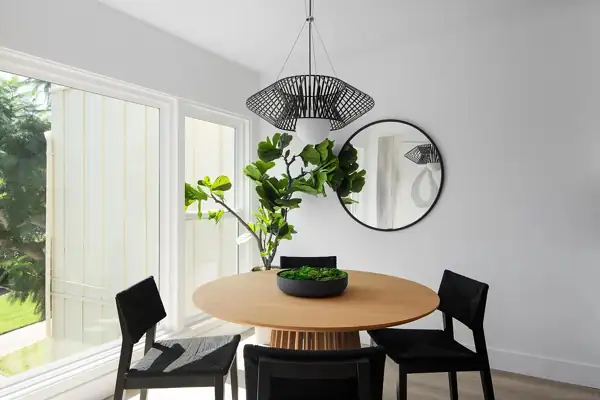 Dining nook with round table and wire pendant